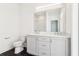 Bathroom with black tile floors, double vanity, and a separate toilet area at 443 Plateau Nw Pl, Atlanta, GA 30309