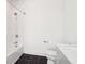 Bathroom with white subway tile in shower, black tile floor and white cabinets at 443 Plateau Nw Pl, Atlanta, GA 30309