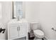Bathroom featuring white cabinets, modern faucet, and white toilet at 443 Plateau Nw Pl, Atlanta, GA 30309