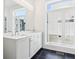 Bright bathroom with black tile floors, double vanity, and a large window at 443 Plateau Nw Pl, Atlanta, GA 30309