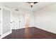 A bright bedroom features hardwood floors and multiple doors leading to a bathroom at 443 Plateau Nw Pl, Atlanta, GA 30309