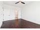 A bright bedroom features beautiful dark hardwood floors and a ceiling fan at 443 Plateau Nw Pl, Atlanta, GA 30309