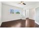 Bright bedroom with hardwood floors features a large window and frosted glass doors at 443 Plateau Nw Pl, Atlanta, GA 30309