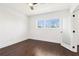 Bright bedroom features hardwood floors, a modern ceiling fan, and a window providing natural light at 443 Plateau Nw Pl, Atlanta, GA 30309