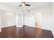 A cozy bedroom with dark hardwood flooring, a ceiling fan, and an en suite bathroom at 443 Plateau Nw Pl, Atlanta, GA 30309