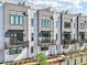 Beautiful exterior of modern townhomes with gray and white siding and private balconies on multiple levels at 443 Plateau Nw Pl, Atlanta, GA 30309