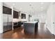 Spacious kitchen with stainless steel appliances, dark wood cabinets, hardwood floors and an oversized island at 443 Plateau Nw Pl, Atlanta, GA 30309