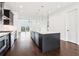 Modern kitchen featuring dark wood cabinets, hardwood floors, stainless steel appliances, and a large center island at 443 Plateau Nw Pl, Atlanta, GA 30309