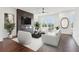 Spacious living room featuring modern fireplace, white furniture, and hardwood floors at 443 Plateau Nw Pl, Atlanta, GA 30309