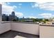 Rooftop view of the city skyline on a sunny day with blue skies and scattered clouds at 443 Plateau Nw Pl, Atlanta, GA 30309