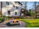 Backyard patio area featuring fire pit, lush lawn, and exterior of home at 4568 Oswood Ct, Tucker, GA 30084