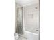 Bathroom featuring white shower tile with niche and rainfall shower head at 4568 Oswood Ct, Tucker, GA 30084
