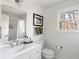 Bright bathroom featuring white vanity and modern fixtures and window views at 4568 Oswood Ct, Tucker, GA 30084