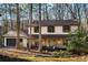 Charming two-story home featuring a stone porch, siding, and a well-maintained yard in a wooded setting at 4568 Oswood Ct, Tucker, GA 30084