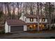 Beautiful two-story home featuring a large garage, classic design, and cozy porch in a wooded setting at 4568 Oswood Ct, Tucker, GA 30084