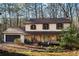 Charming two-story home featuring a stone porch, attached garage, and a serene wooded setting at 4568 Oswood Ct, Tucker, GA 30084