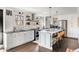 Bright, updated kitchen with white cabinetry, stainless steel appliances, island with seating and hardwood floors at 4568 Oswood Ct, Tucker, GA 30084