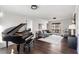 Open living room with piano, hardwood floors, large window, and neutral decor at 4568 Oswood Ct, Tucker, GA 30084