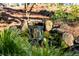A serene rock water feature surrounded by lush greenery in the garden at 4568 Oswood Ct, Tucker, GA 30084