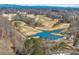 Stunning aerial view of the golf course, pond, and surrounding neighborhood at 602 Davenport Pl, Canton, GA 30115