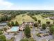 Stunning aerial view of community amenities including a golf course, pool, clubhouse, and tennis courts at 602 Davenport Pl, Canton, GA 30115