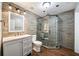 Beautiful bathroom with stone tiled walls, a glass shower, and a vanity sink at 602 Davenport Pl, Canton, GA 30115