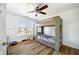 Bright bedroom features a wood bunk bed, ceiling fan, and large window with a view at 602 Davenport Pl, Canton, GA 30115