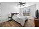Bright bedroom featuring a queen size bed, hard wood floors, and a ceiling fan at 602 Davenport Pl, Canton, GA 30115