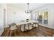 Elegant dining room featuring wainscoting, modern lighting, and a large window creating an inviting atmosphere for gatherings at 602 Davenport Pl, Canton, GA 30115
