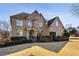 Stately brick home featuring a manicured lawn and traditional architectural details at 602 Davenport Pl, Canton, GA 30115