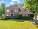 Charming brick home with a well-kept lawn, mature landscaping, and a welcoming front entrance with detailed trim at 602 Davenport Pl, Canton, GA 30115