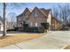 Charming brick home with a well-manicured lawn and a long driveway leading to a basketball court at 602 Davenport Pl, Canton, GA 30115