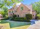 Beautiful brick home with a well-manicured lawn and mature landscaping at 602 Davenport Pl, Canton, GA 30115