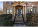 Inviting front porch with brick steps and column supports offering a warm welcome to this charming home at 602 Davenport Pl, Canton, GA 30115
