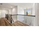 Hallway with a black metal handrail and view of the chandelier at 602 Davenport Pl, Canton, GA 30115