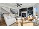 Bright living room featuring a fireplace, built-in shelving, and a modern ceiling fan at 602 Davenport Pl, Canton, GA 30115