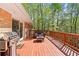 Expansive back deck with a gas grill, outdoor furniture, and beautiful wooded surroundings at 1618 Cooper Lake Se Rd, Smyrna, GA 30082
