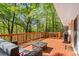 Inviting back deck with a gas grill, outdoor furniture, and a scenic wooded view at 1618 Cooper Lake Se Rd, Smyrna, GA 30082