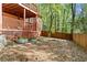 Backyard with lower covered deck, featuring mature trees and a wood fence at 1618 Cooper Lake Se Rd, Smyrna, GA 30082