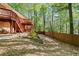 Spacious backyard featuring a multi-level deck, stone retaining wall, and fenced perimeter at 1618 Cooper Lake Se Rd, Smyrna, GA 30082