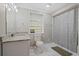 Bright bathroom features a granite vanity and shower-tub combination at 1618 Cooper Lake Se Rd, Smyrna, GA 30082