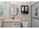 A modern bathroom featuring a granite vanity top, modern fixtures, and window at 1618 Cooper Lake Se Rd, Smyrna, GA 30082