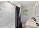 A bathroom with white tile, dark shower curtain, and brushed black faucet at 1618 Cooper Lake Se Rd, Smyrna, GA 30082