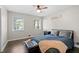 Well-lit bedroom with hardwood floors, ceiling fan, and three large windows at 1618 Cooper Lake Se Rd, Smyrna, GA 30082