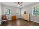 Bedroom featuring hardwood floors, a ceiling fan, and natural light at 1618 Cooper Lake Se Rd, Smyrna, GA 30082