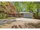 Brick home with attached garage and circular drive, nestled among mature trees at 1618 Cooper Lake Se Rd, Smyrna, GA 30082
