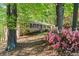 Brick home exterior with lush green landscaping and flowering shrubbery in a wooded setting at 1618 Cooper Lake Se Rd, Smyrna, GA 30082