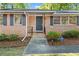 Brick front entrance with storm door, updated shutters, and security system sign at 1618 Cooper Lake Se Rd, Smyrna, GA 30082