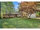Charming brick home featuring mature landscaping and a well-manicured lawn at 1618 Cooper Lake Se Rd, Smyrna, GA 30082