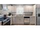 This home features a neutral kitchen with a double sink and stainless steel dishwasher at 1618 Cooper Lake Se Rd, Smyrna, GA 30082